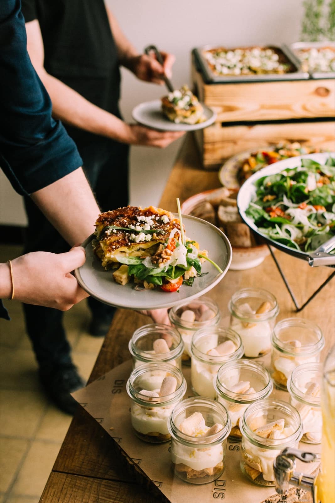A generous, handmade buffet by DIS with lasagne, salads and desserts for an event