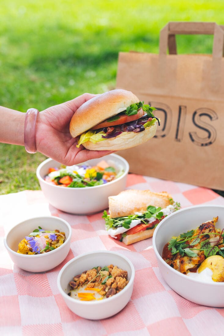 A wooden DIS crate of sandwiches and quiches, as it is delivered to the office