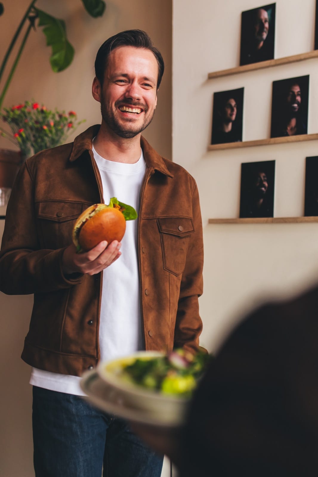 A smiling guest with a fresh DIS sandwich at the office